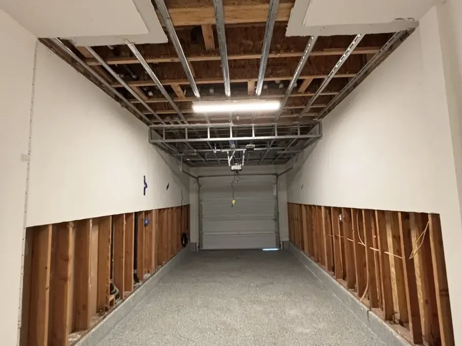 Garage walls opened with flood cuts after a water heater leak