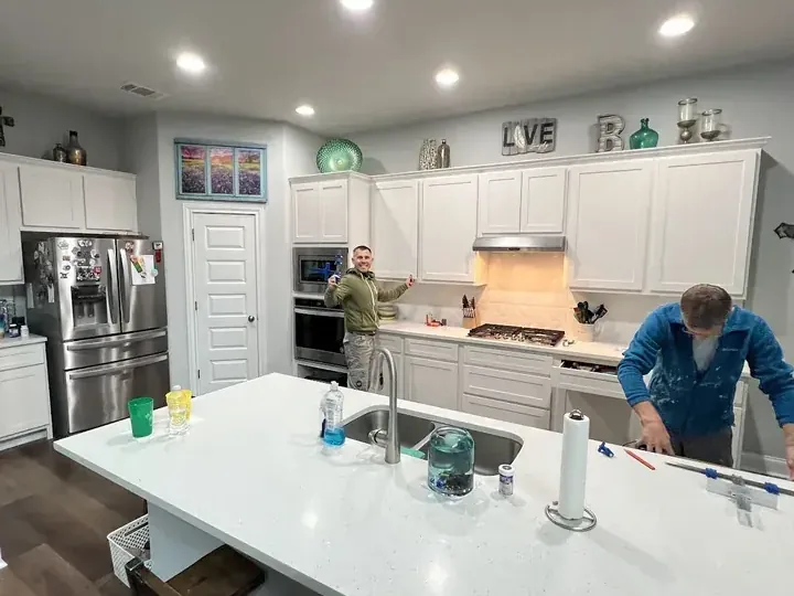 Crew rebuilding a kitchen after a supply hose leak