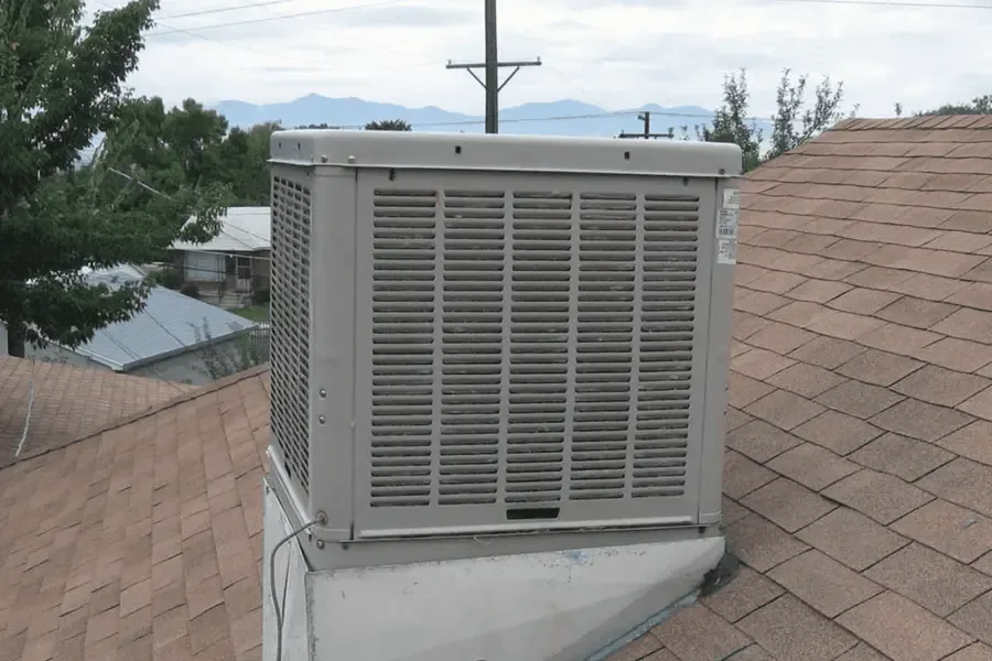 Rooftop evaporative swamp cooler on a home, a common source of leaks